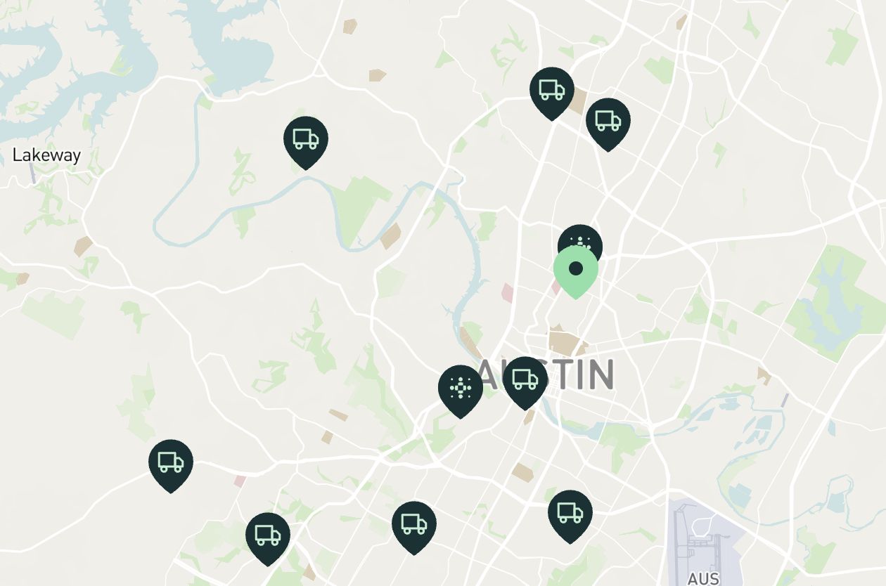 A map showing the locations of mobile DEXA scan trucks and a central office location in Austin, Texas. The locations are marked by truck icons and a green pin.