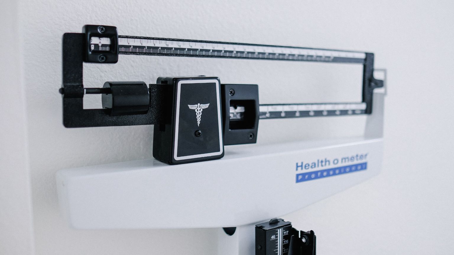 A close-up shot of a white and black Health o meter professional medical scale.